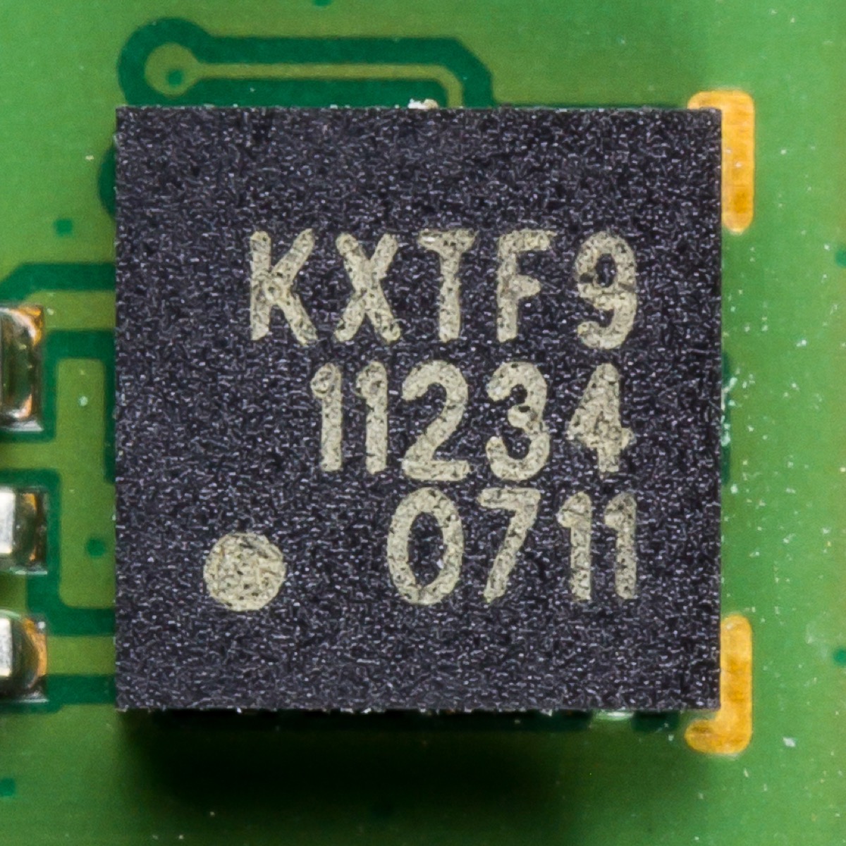 Close-up macro photo of a Kionix MEMS tri-axis accelerometer chip from a mobile device