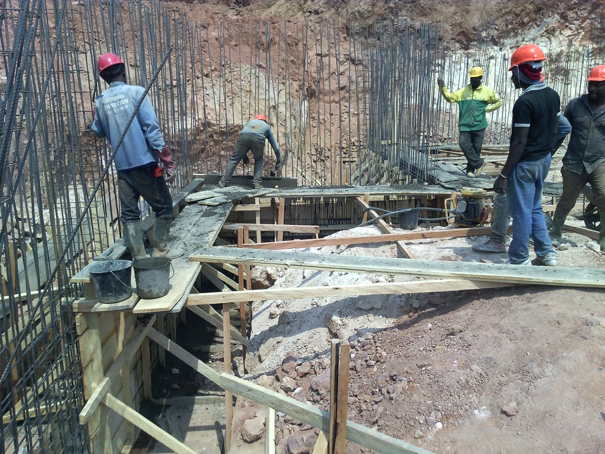 Construction workers checking a wall during building work