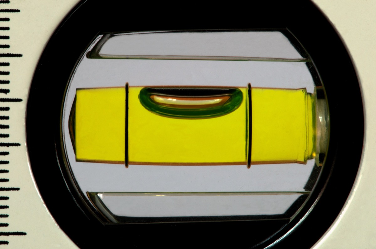Close-up of a spirit level bubble vial centered between the guide lines