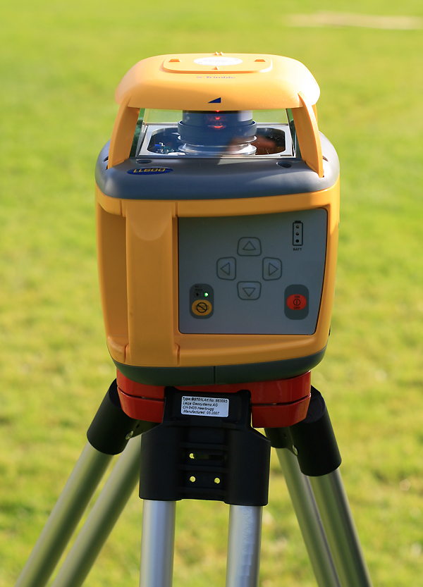 A Trimble rotating construction laser level used on a building site for horizontal alignment