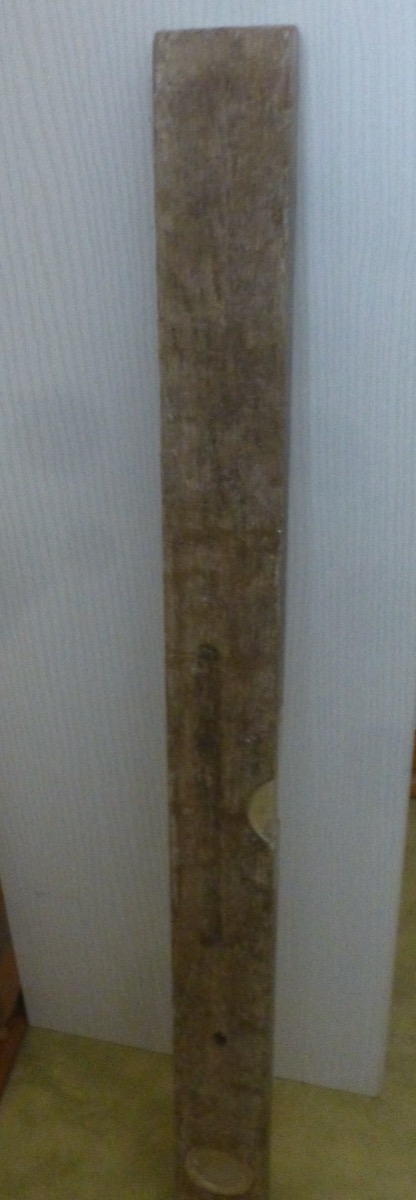 An antique wooden spirit level showing traditional construction tool craftsmanship