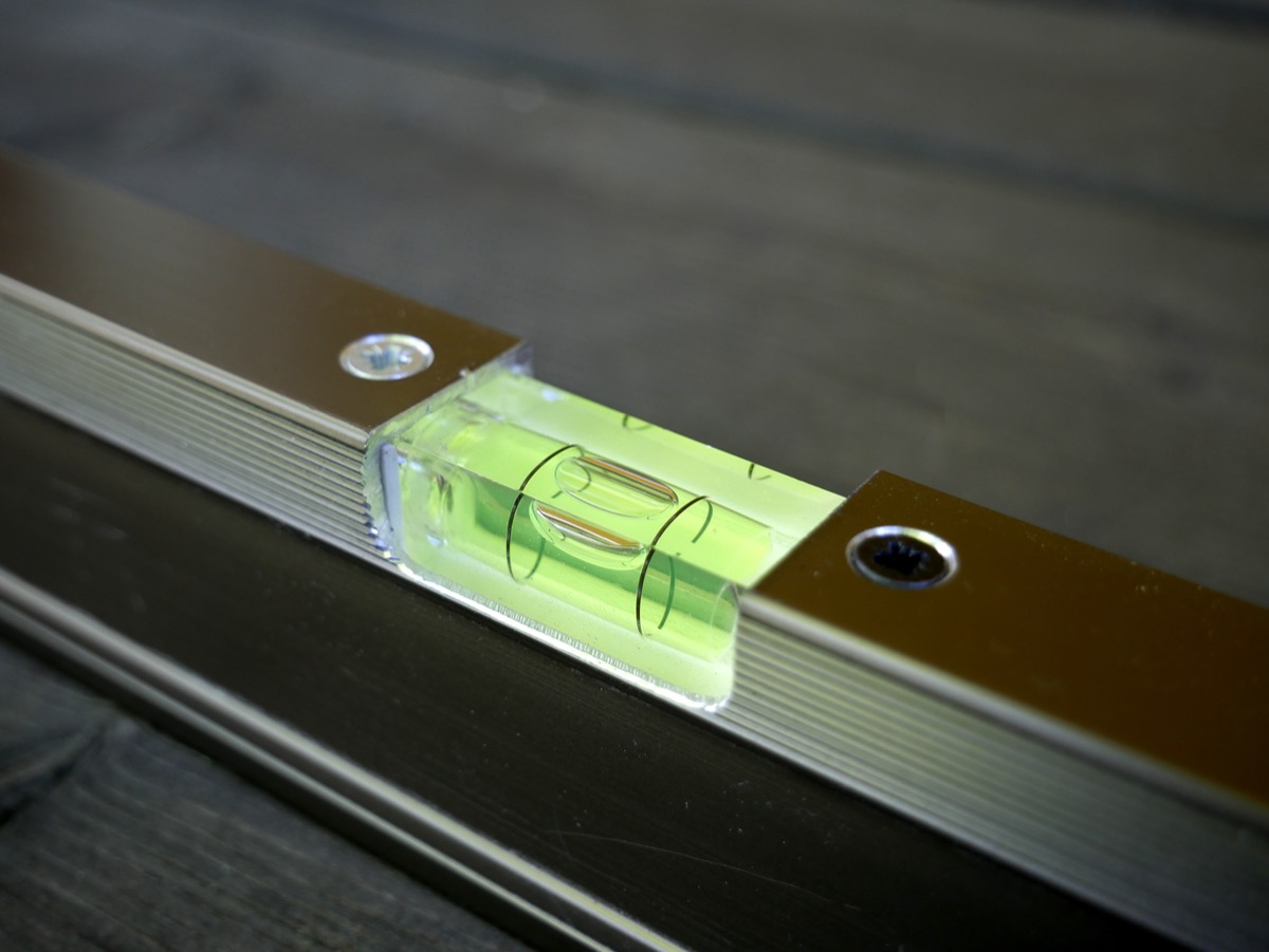 Close-up photograph of a spirit level bubble vial showing the bubble perfectly centered between the lines